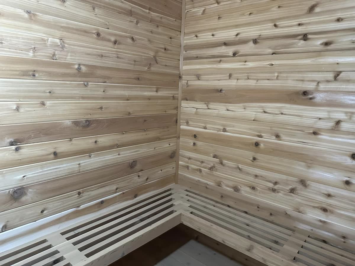 Knotty wood boards lining the walls of a room.