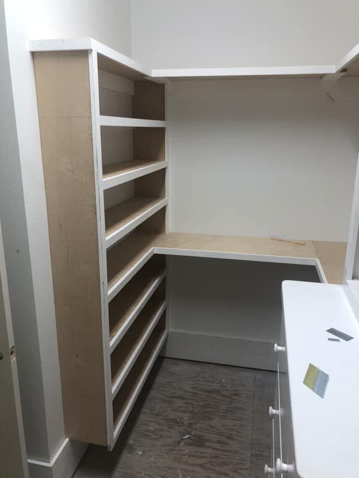 Built-in shelves floor to ceiling in a walk-in closet.
